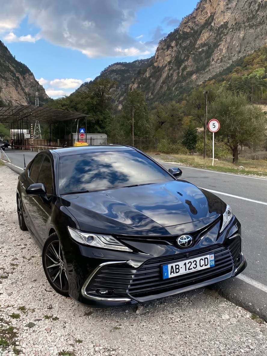 A parked saloon car, then the same shot with a sports car.