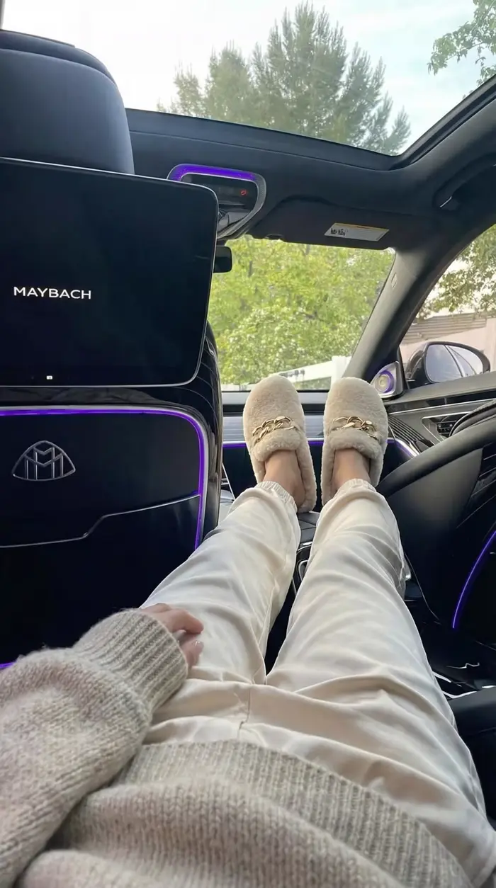 Legs stretched out in the back seat of a Maybach.